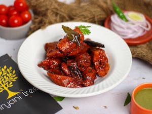 An appetizing Indian chicken dish garnished with spices, captured beautifully in an indoor setting.
