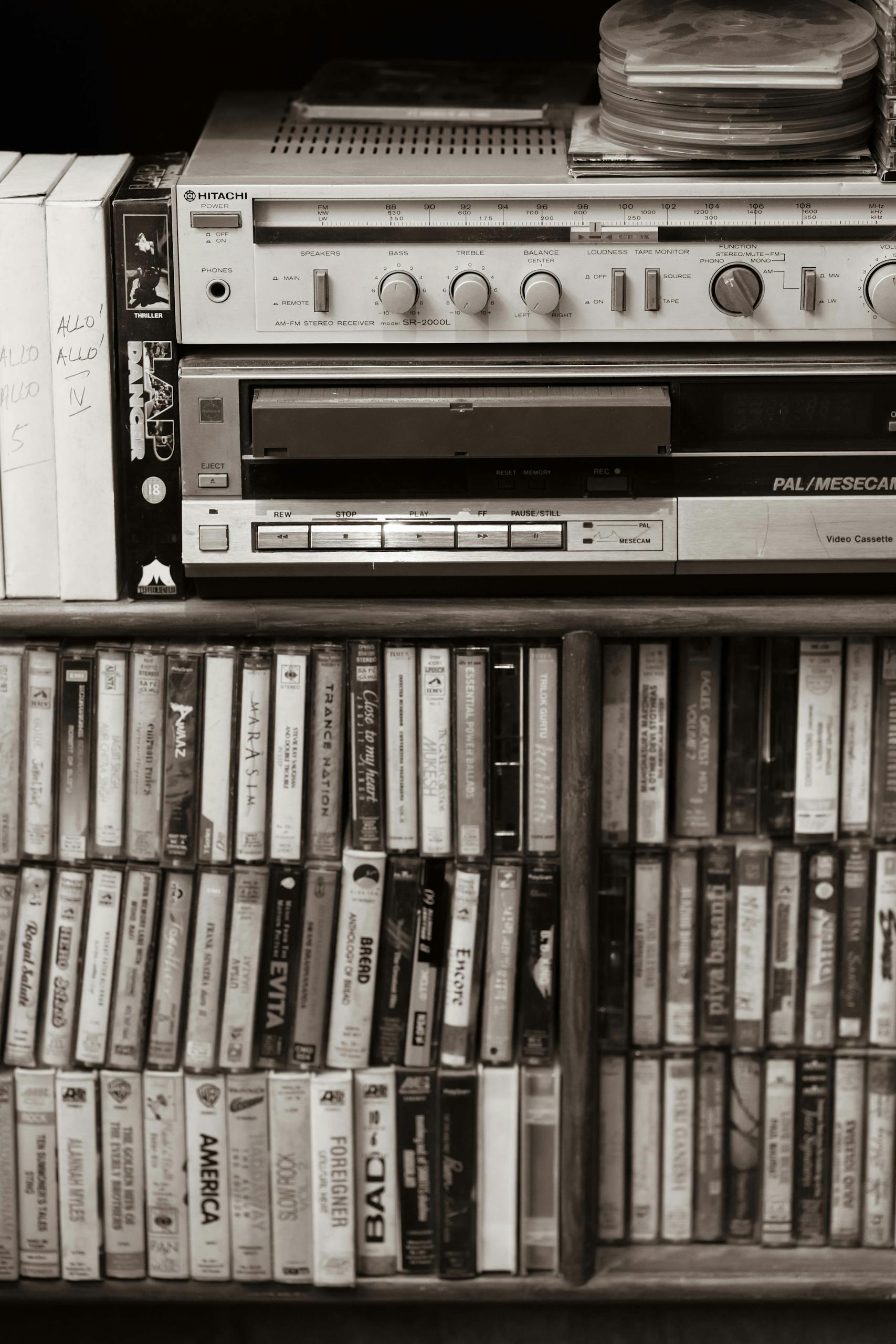 Classic audio setup with cassette tapes and retro sound equipment in sepia tone.