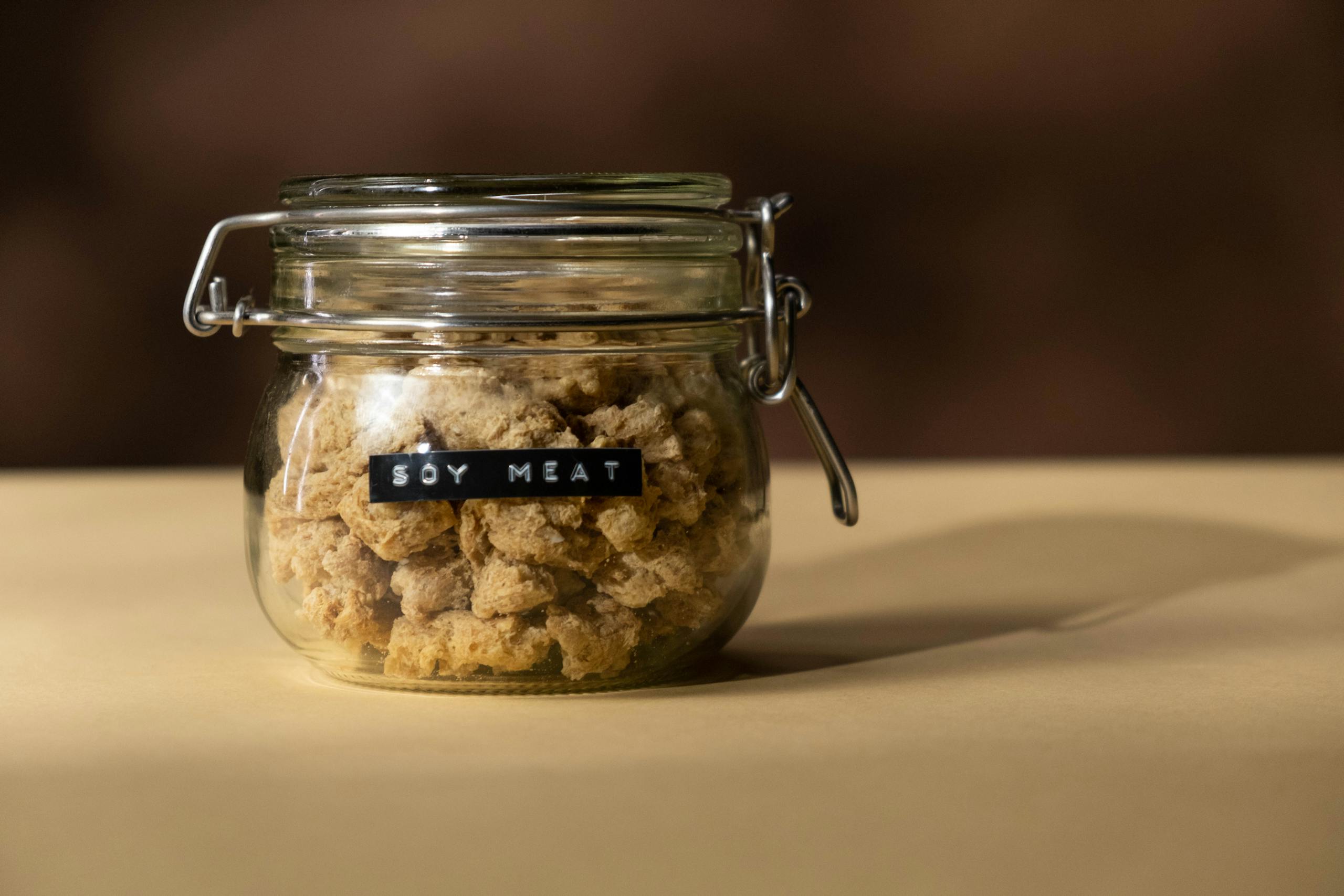 Close-up of a glass jar filled with soy meat, ideal for vegan and vegetarian recipes.