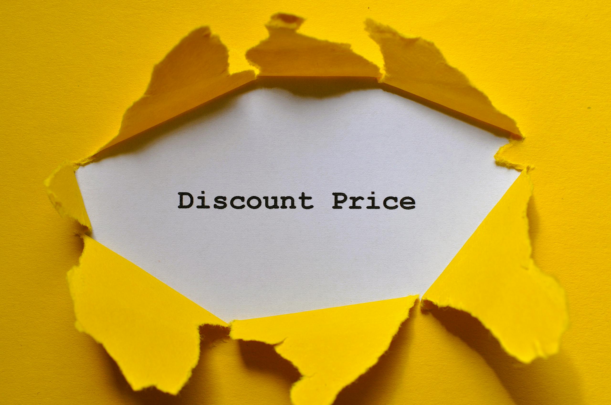 Eye-catching image of torn yellow paper revealing the words 'Discount Price.'