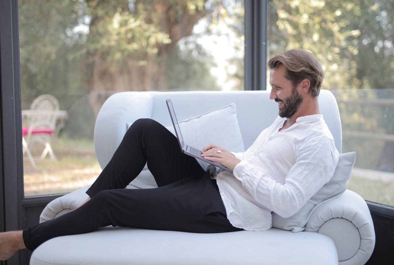 man sitted in uncomfortable posture using a laptop