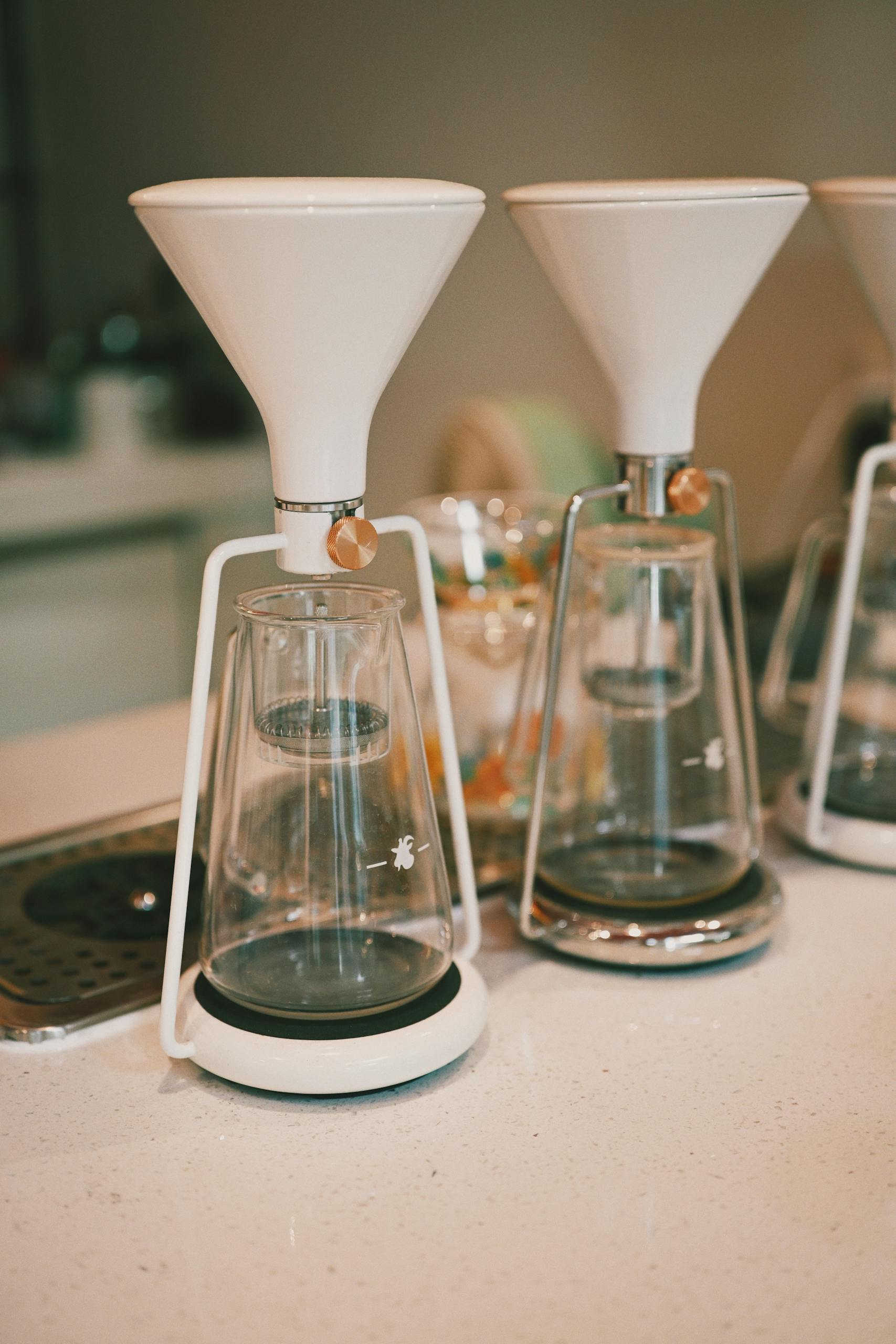 Stylish modern coffee makers displayed on a clean kitchen counter, perfect for brewing enthusiasts.