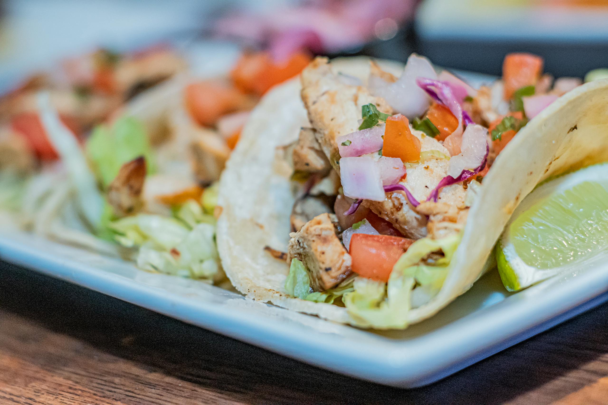 Tantalizing close-up of mouthwatering chicken lime tacos, perfect for food lovers.