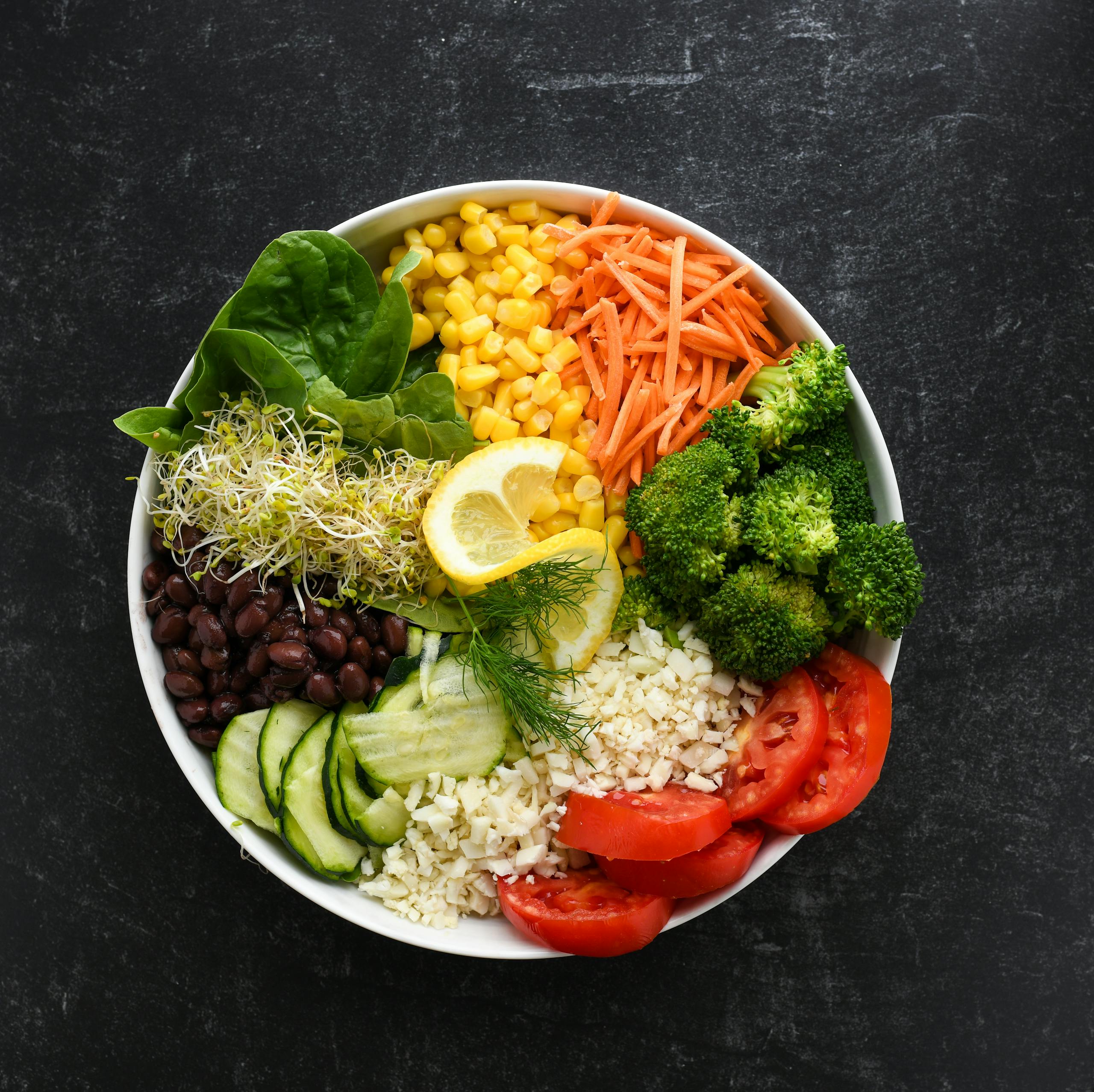 Top view of a vibrant salad bowl with fresh vegetables for a healthy meal.