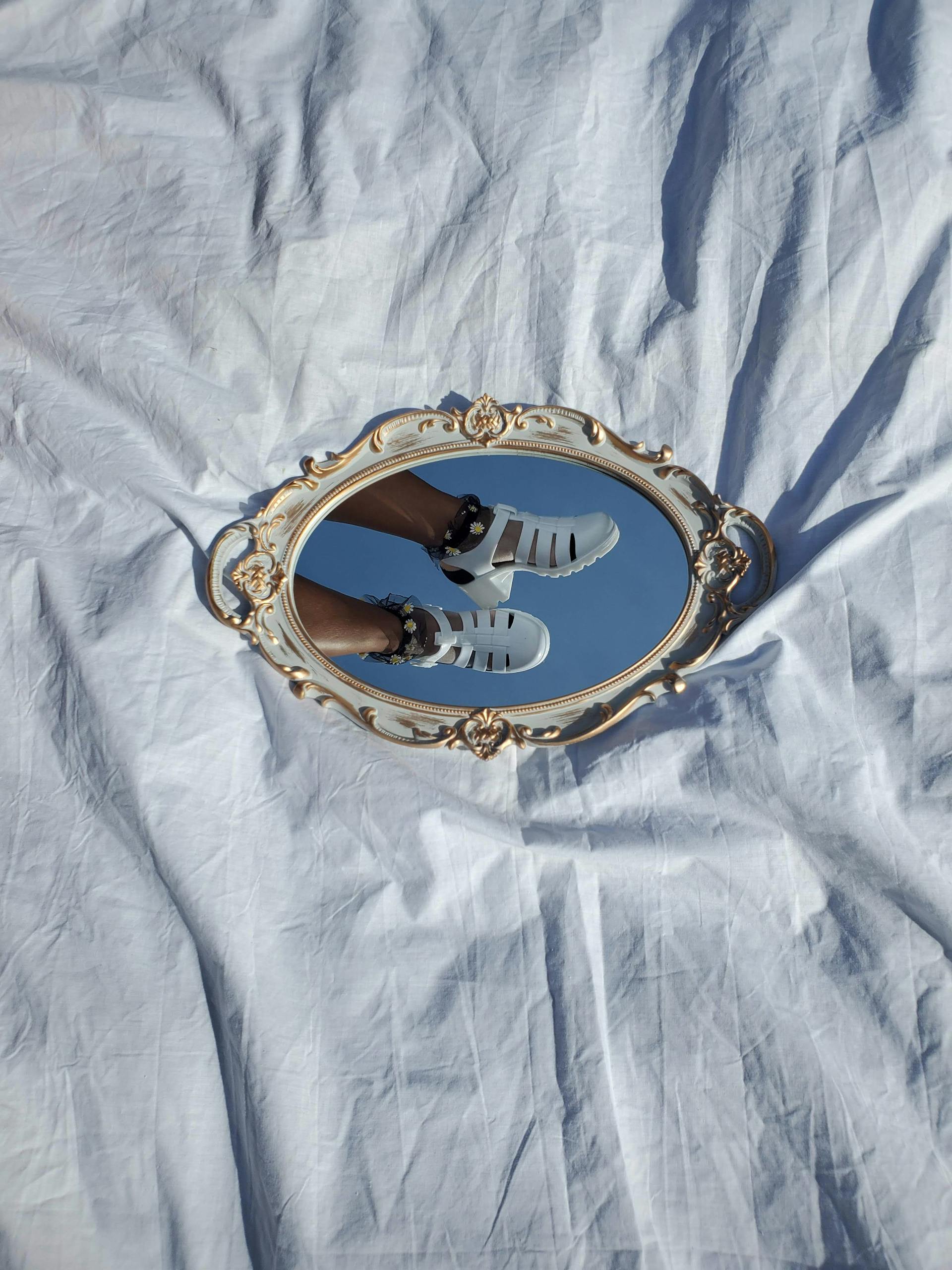 Unique composition of sandals mirrored on fabric, incorporating vintage style.