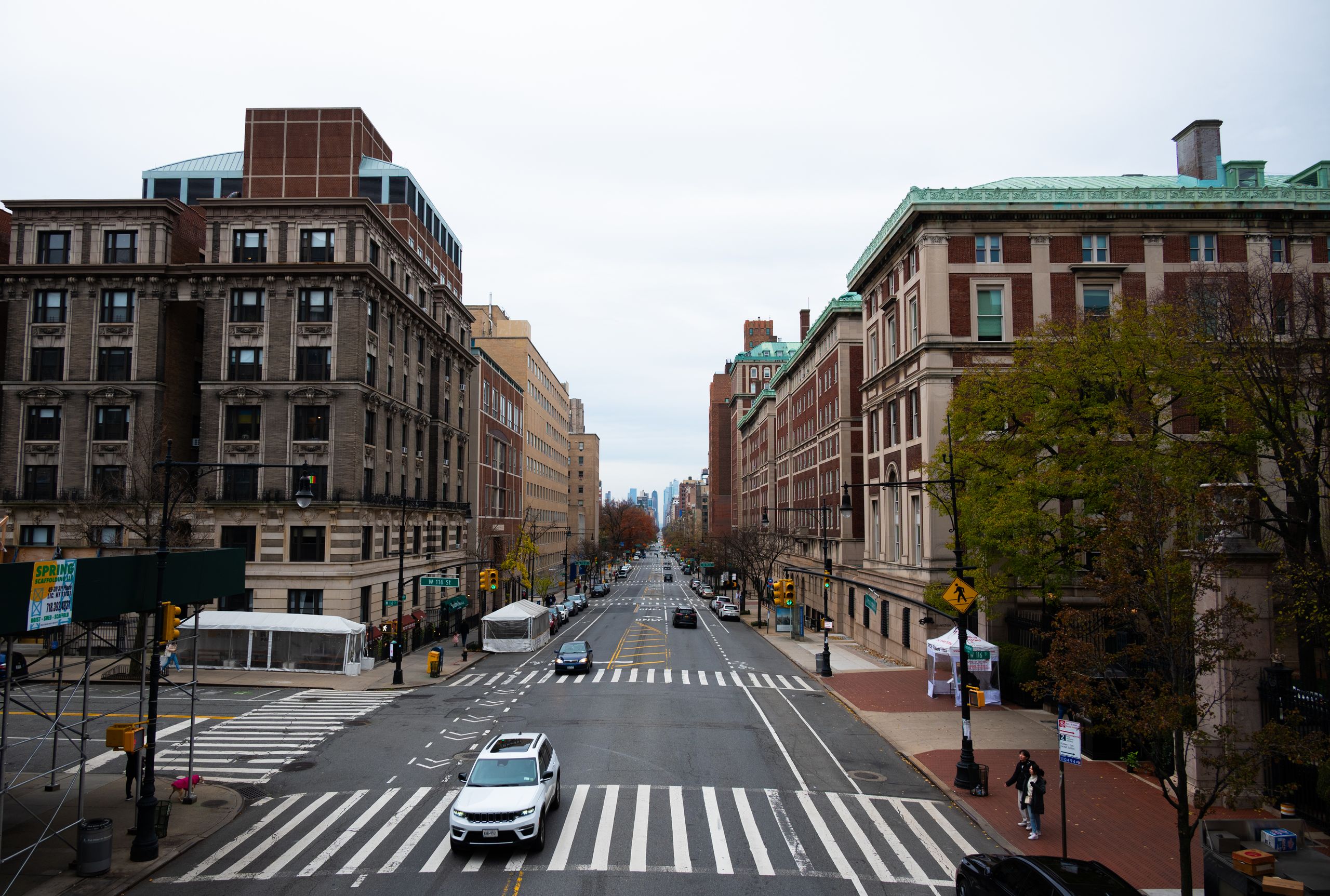 An urban scene showcasing a quiet street in New York City with classic architecture lining both sides.