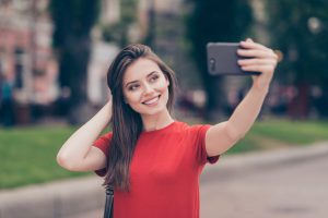 Straight-haired young beautiful smiling girl wearing casual red