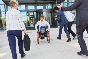 Business people run next to businesswoman in wheelchair to congress or office