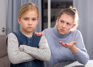 Dissatisfied mother scolds little girl