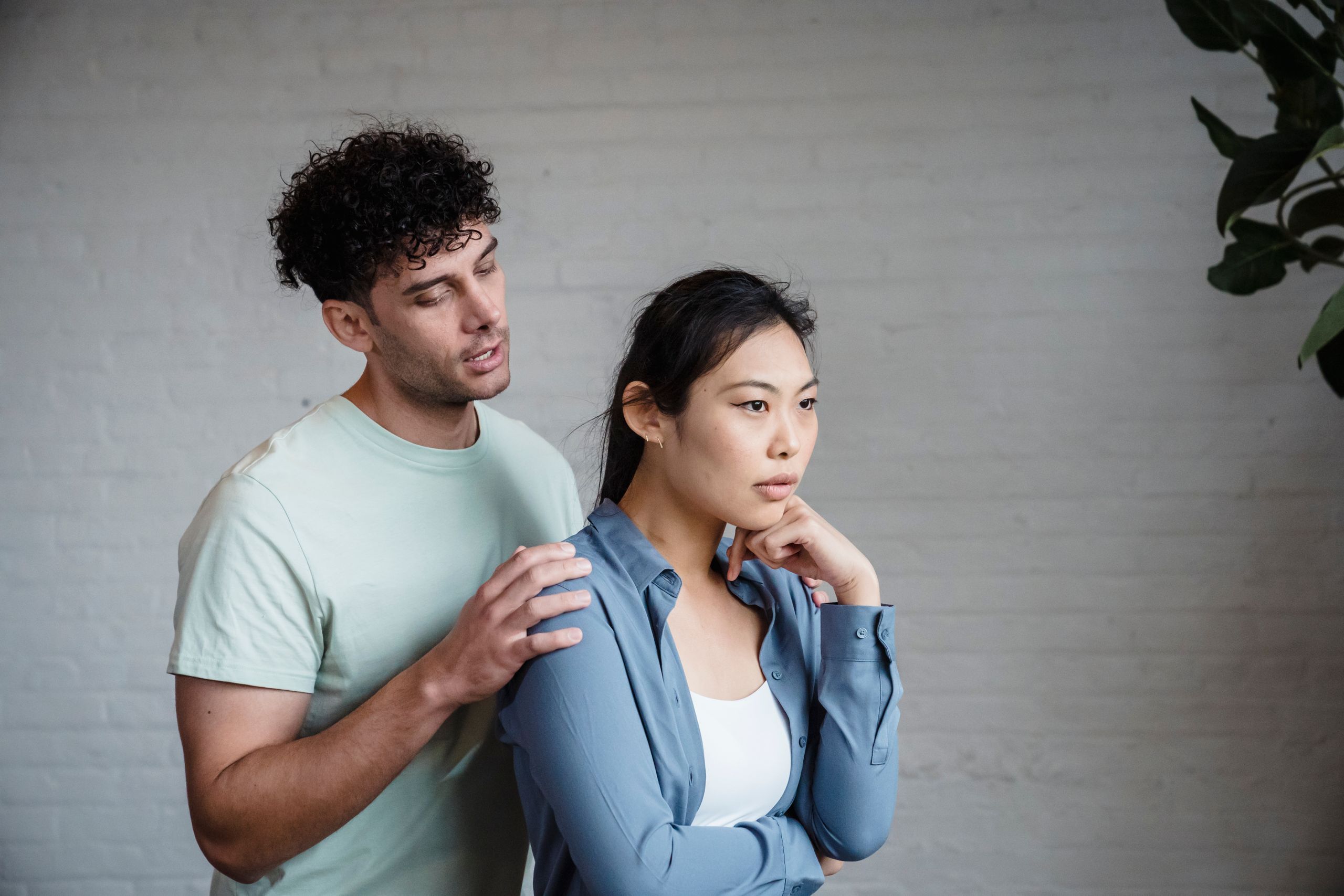 A couple engaged in emotional discussion indoors, reflecting relationship dynamics.