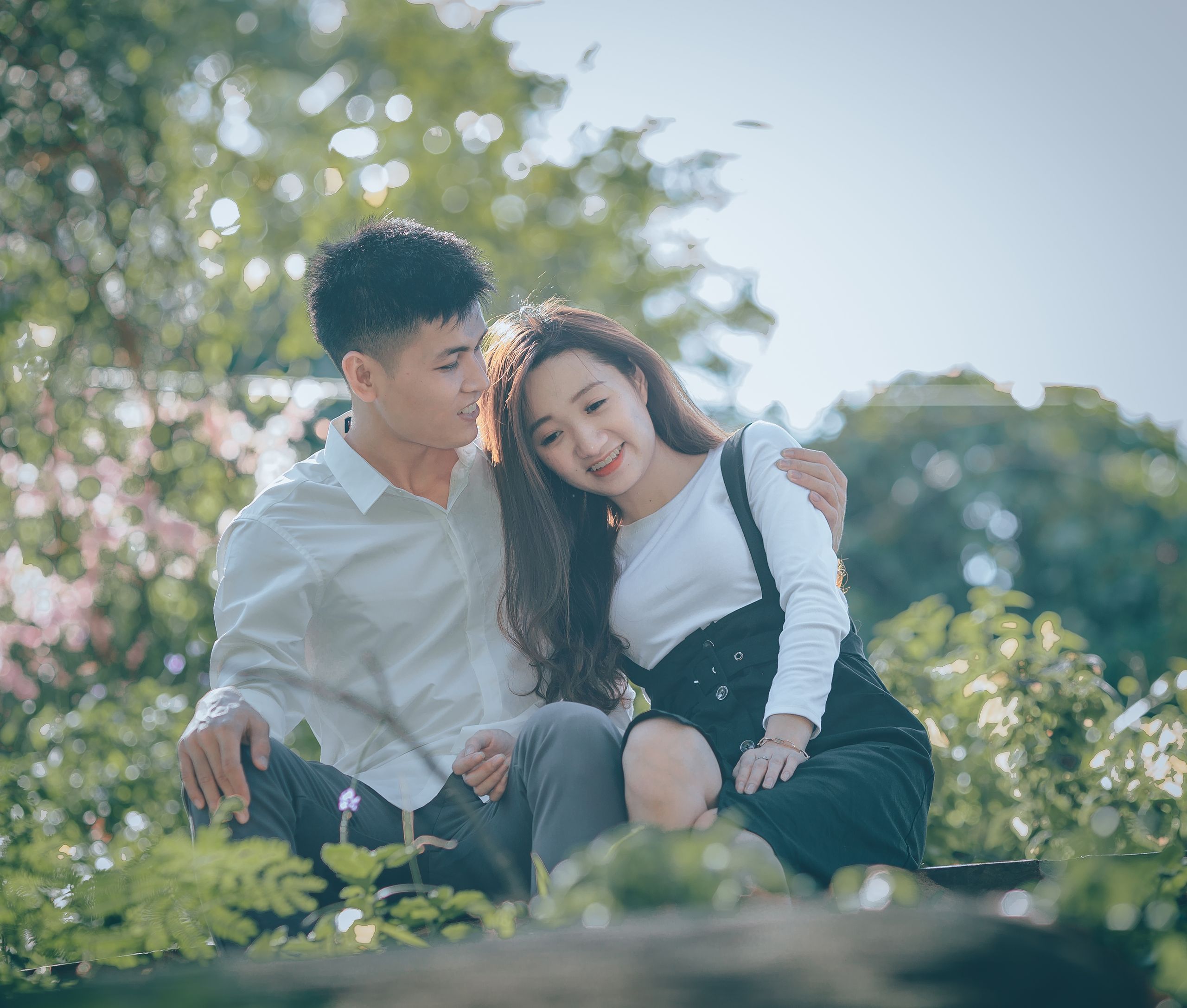 A couple enjoying a relaxing moment in nature with warmth and happiness.