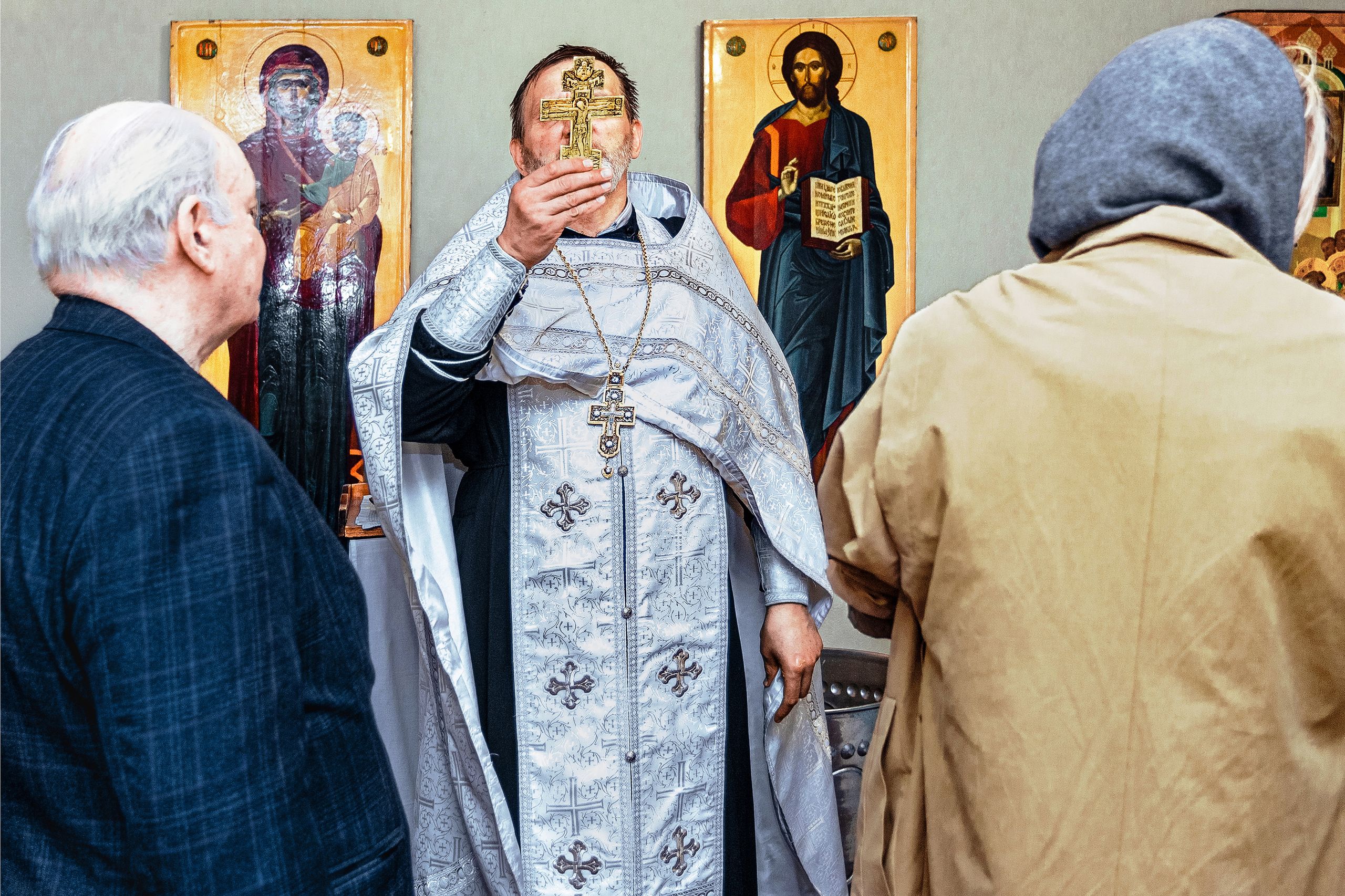 An Orthodox priest leads a religious ceremony with icons in Moscow, Russia.