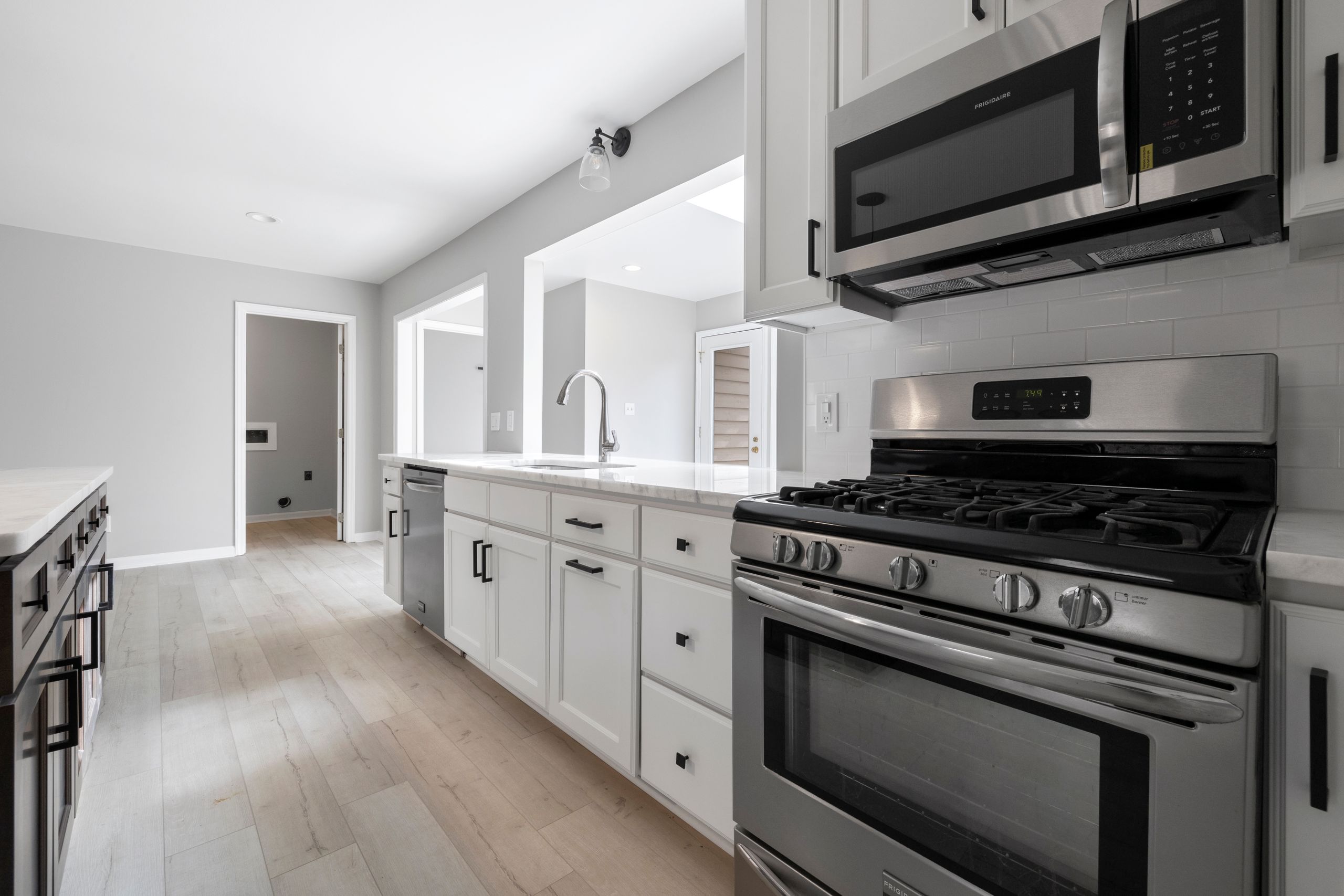 Bright, sleek kitchen interior featuring stainless steel appliances and white cabinetry for a modern design.
