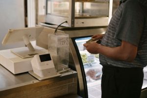crop-man-standing-near-cash-machine