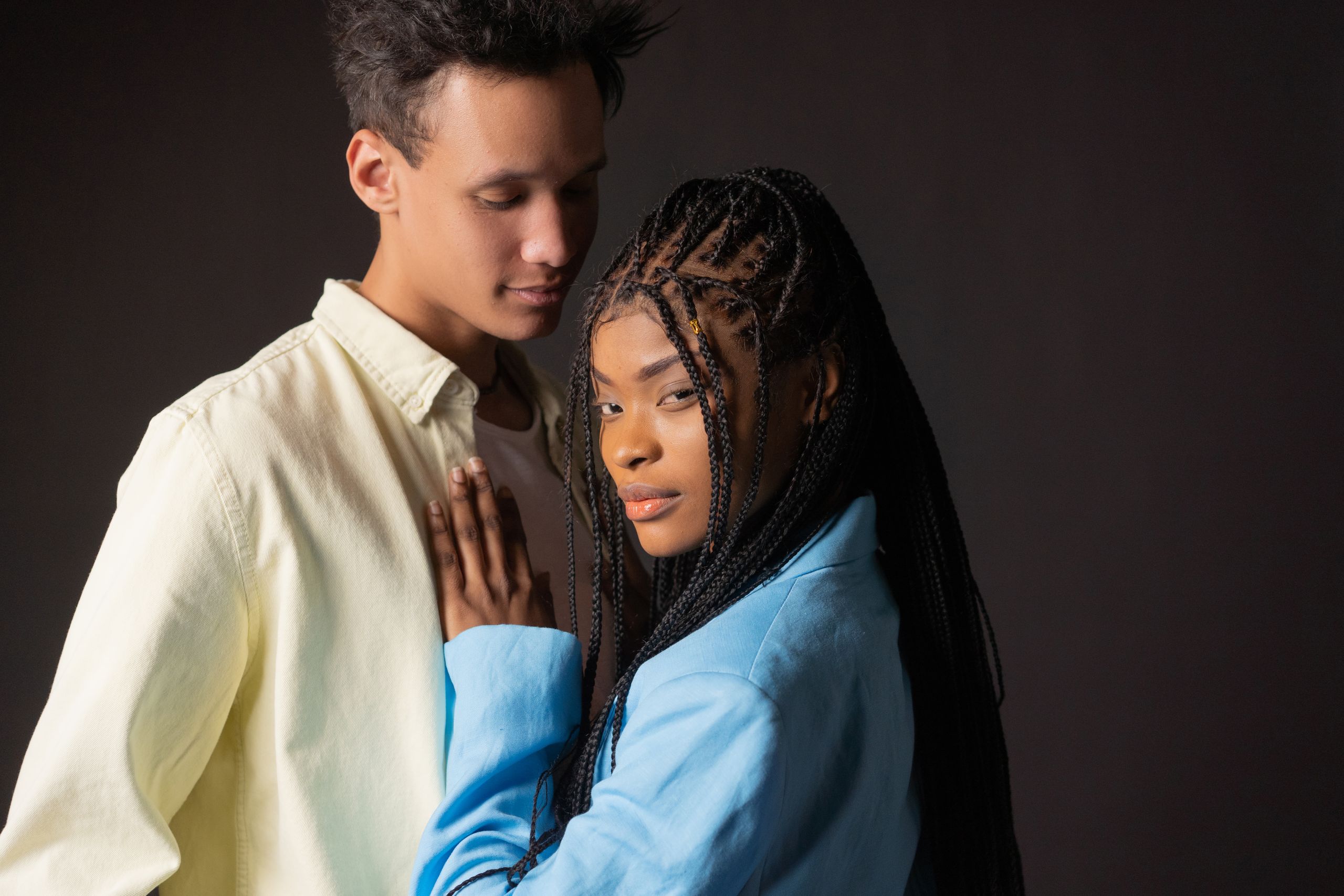 A loving couple close with intimate expressions in a studio environment.